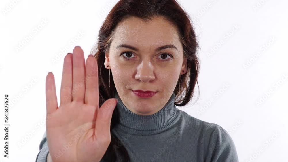 Stop hand sign. Woman shows stop hand gesture meaning something or someone to stop right now. Stop hand sign. Woman shows stop hand gesture meaning something or someone to stop right now.