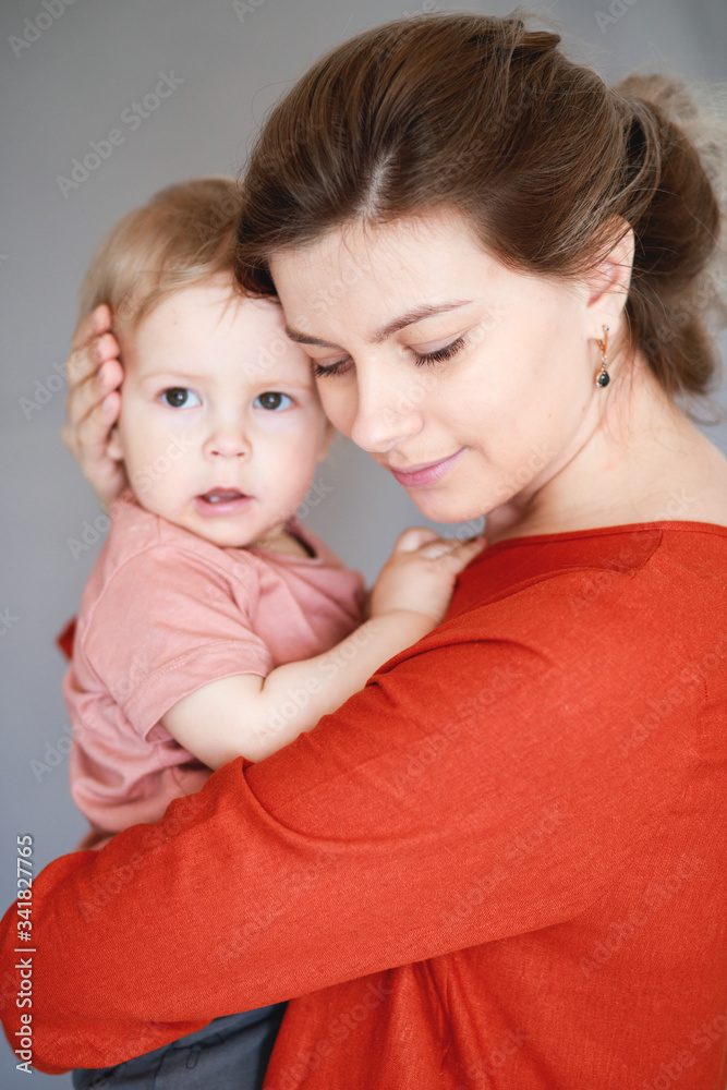 A young mother with her one-year-old little son A young mother with her one-year-old little son