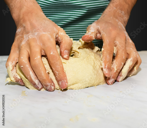 Hands of man kneading, home cooking scene. Kitchen scene for cooking bread, pasta and sweets