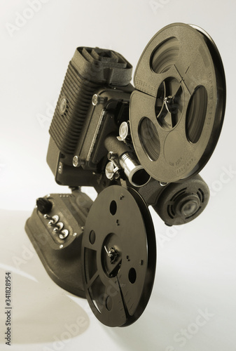 A vintage film projector over a white background.