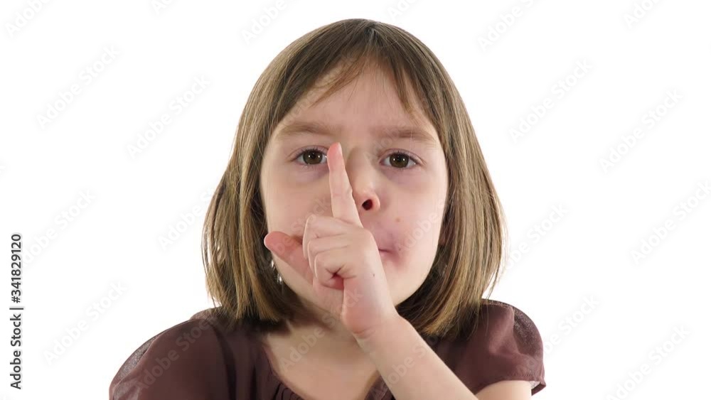 Little girl 5-6 years, blonde, show silence gesture. Child bring her index finger in front of mouth. Little girl 5-6 years, blonde, show silence gesture. Child bring her index finger in front of mouth.