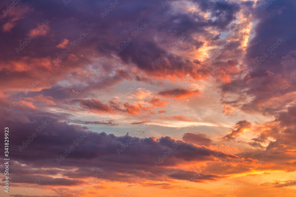 Sky covered with colorful clouds at sunset.