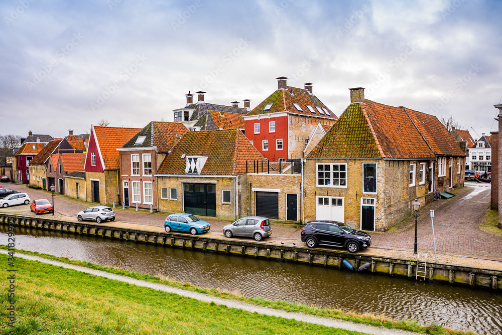 Harlingen, Netherlands - January 10, 2020. Zoutsloot steet with water canal with traditional dutch houses