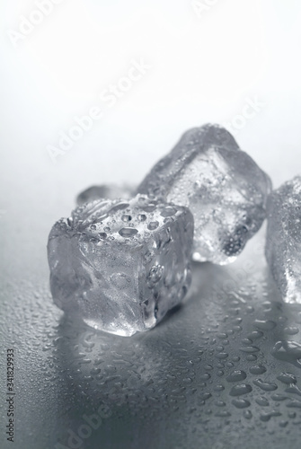 Some thawing ice cubes on a tabletop.