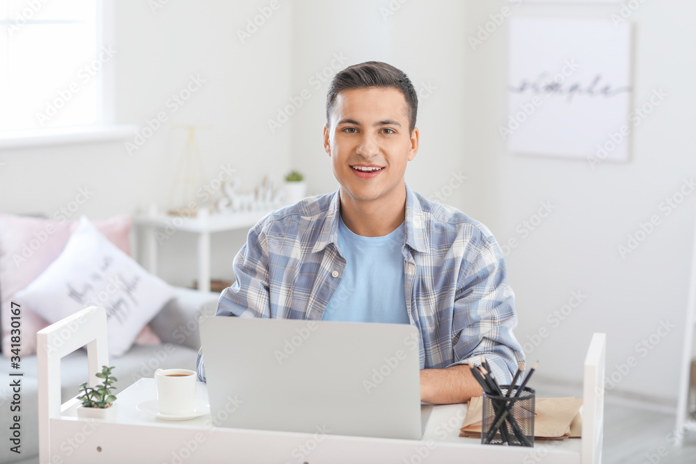 Young man with laptop checking his e-mail at home Young man with laptop checking his e-mail at home