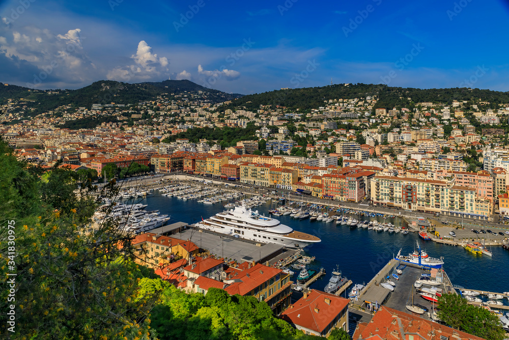 View of boats, coastline and traditional houses in Lympia port on the Mediterranean Sea, Cote d'Azur in Nice, France