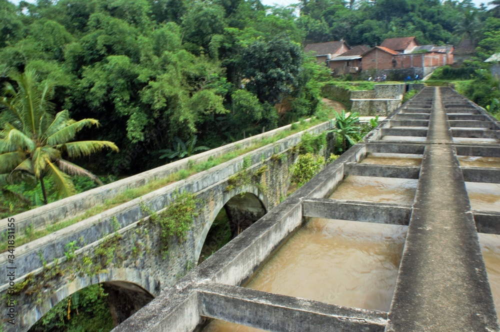old bridge over the river in central java, indonesia