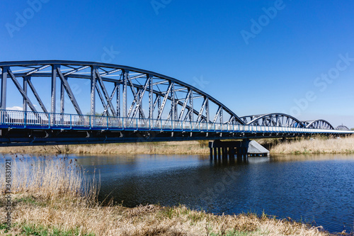Metal bridge background. Road transportation architecture construction. Long bridge over Narew river. Tykocin village in Poland.