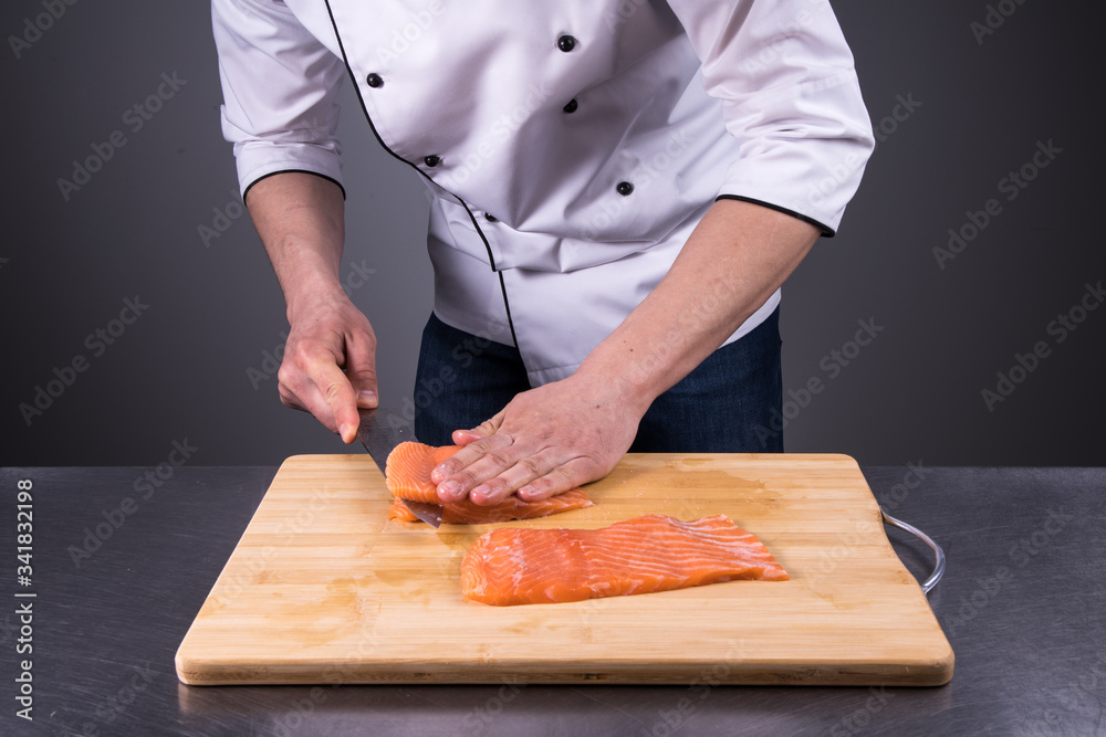 chef cuts salmon for fresh sushi in a restaurant kitchen5