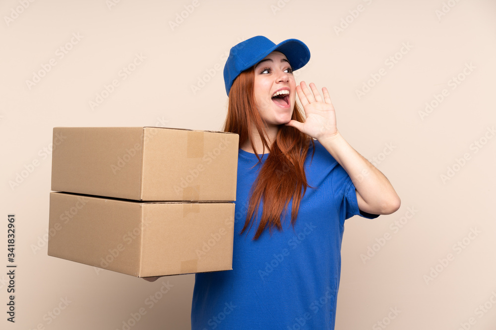 Young teenager delivery girl over isolated background shouting with mouth wide open Young teenager delivery girl over isolated background shouting with mouth wide open