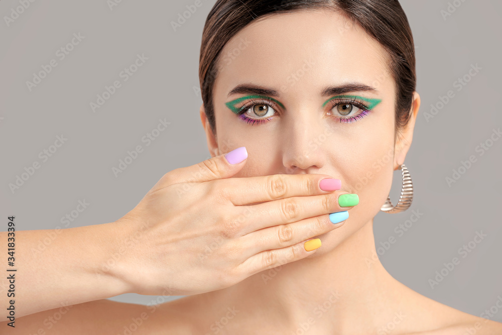 Young woman with beautiful manicure on grey background Young woman with beautiful manicure on grey background