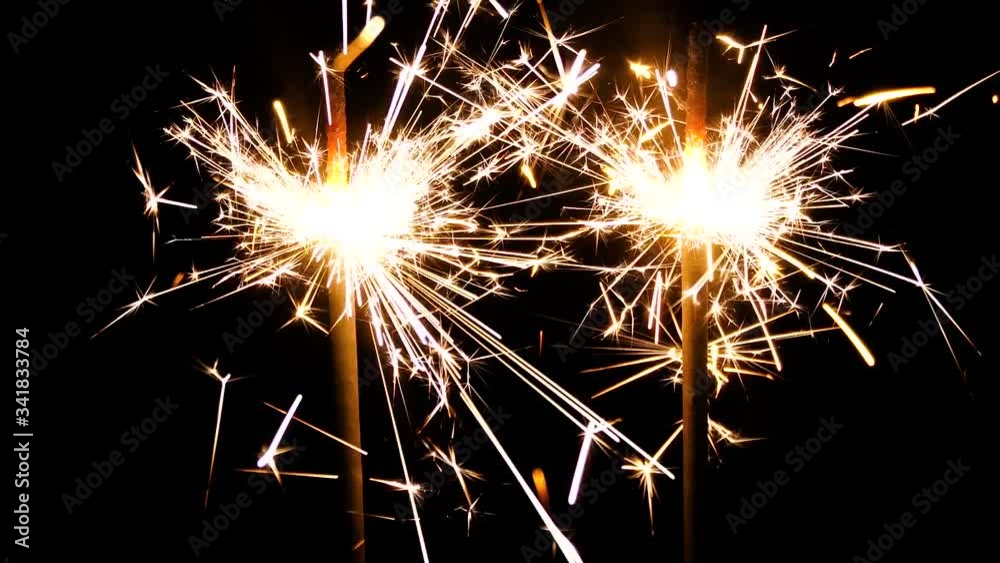 Celebration party, birthday or winter holidays backdrop. Bengal lights are burning on a black background. Holiday party concept. Celebration party, birthday or winter holidays backdrop. Bengal lights are burning on a black background. Holiday party concept.
