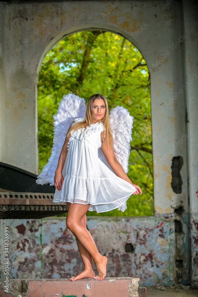 Portrait of beautiful woman with white angel wings on