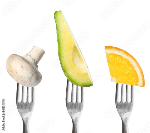 Forks with different vegetables and fruits on white background. Healthy meal