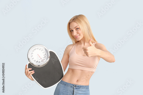 Slim woman with scales show...