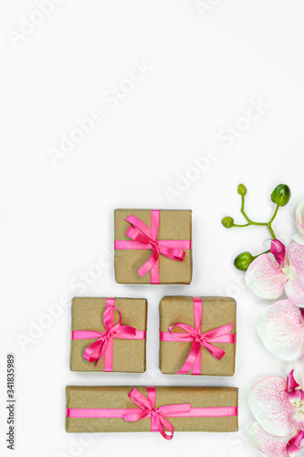 flatlay Gift present boxes pink ribbon, orchid flowers on white backgroun. spring concept. Copy space © olga_demina