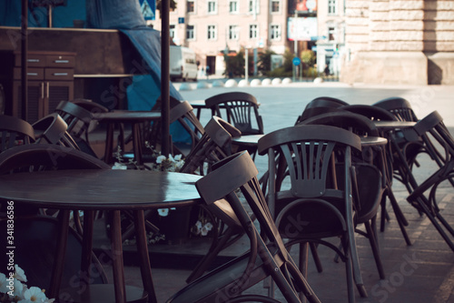  Empty tables and chairs near the closed street cafe photo