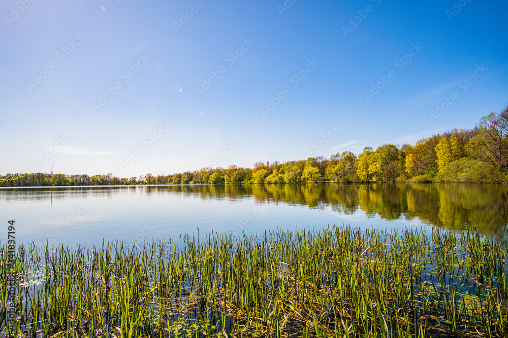 Beautiful, blue and deserted Unisee - a lake in Bremen at sun and blue sky