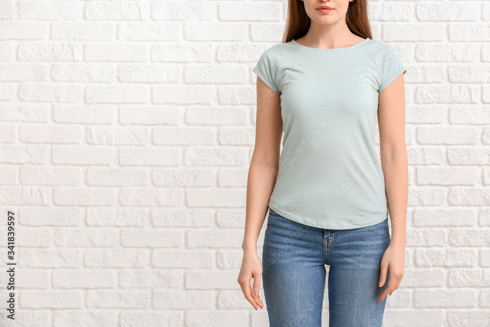 Young woman in stylish t-shirt on white background