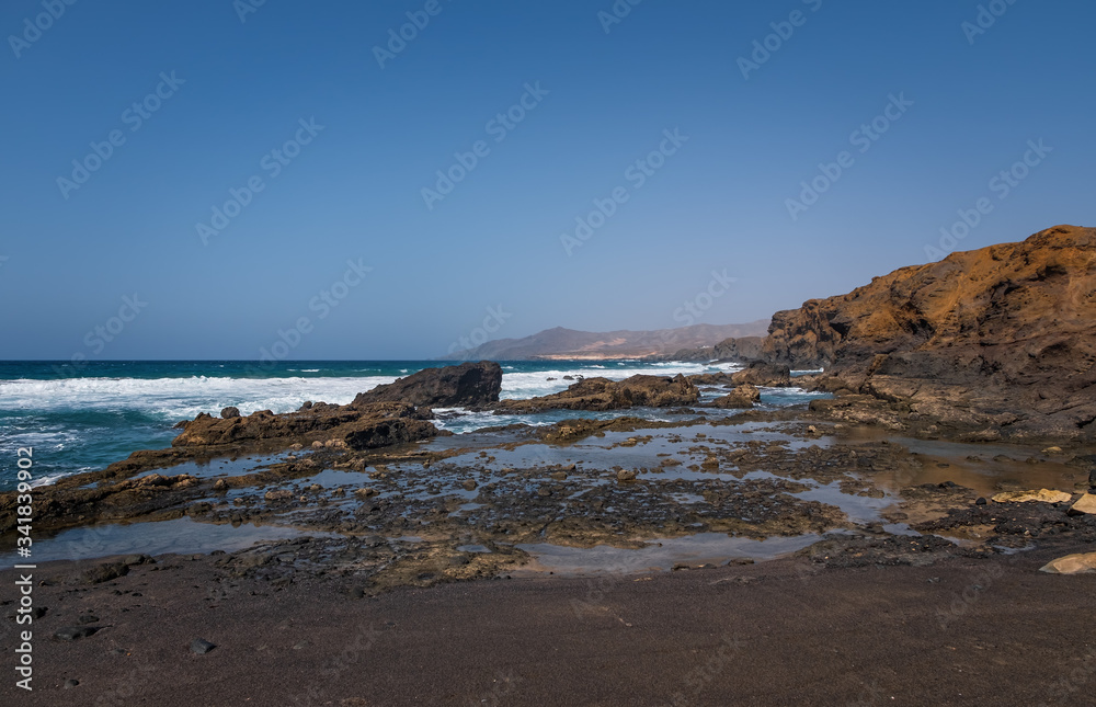 La Pared volcanic beach or Playa de La Pared on Fuerteventura south west coast, Canary Islands, Spain, with eroded landscape and black sand. October 2019