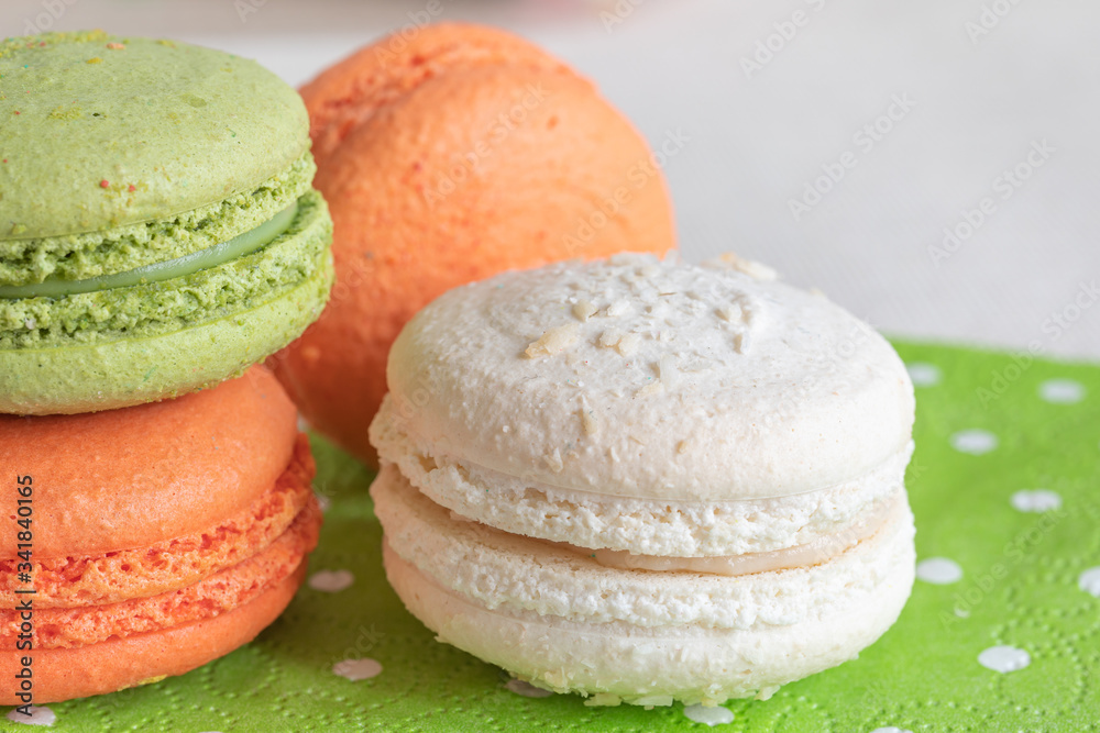 Multi-colored macaroonson a light green napkin. Macarons or macaroons is French or Italian dessert. Multi-colored macaroonson a light green napkin. Macarons or macaroons is French or Italian dessert.