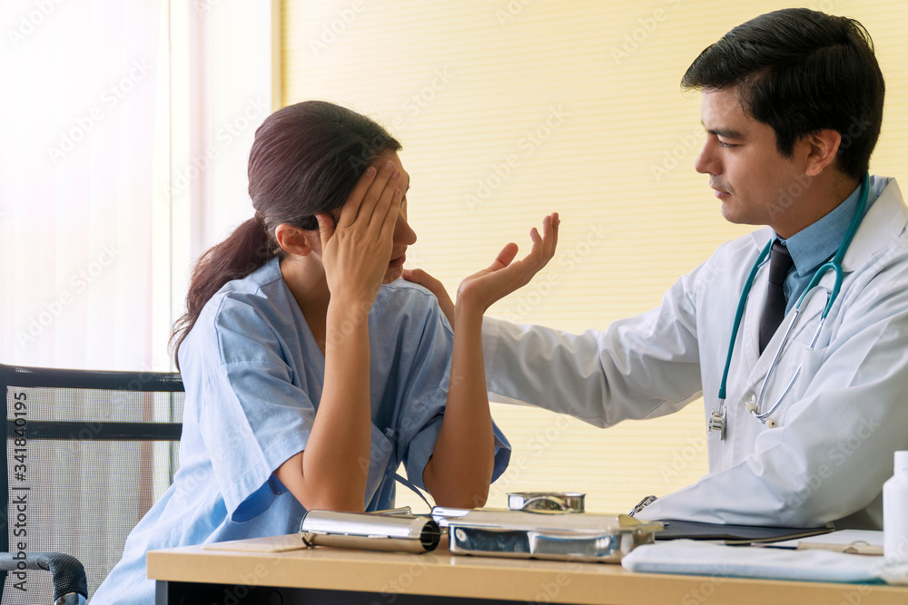 Doctor man wear uniform with pen and stethoscope sitting in office while talking about problem health patient woman fell friendly. Patient young woman listen advice doctor. Health-care concept. Doctor man wear uniform with pen and stethoscope sitting in office while talking about problem health patient woman fell friendly. Patient young woman listen advice doctor. Health-care concept.