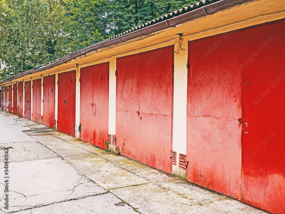 A row of garages with red gates A row of garages with red gates