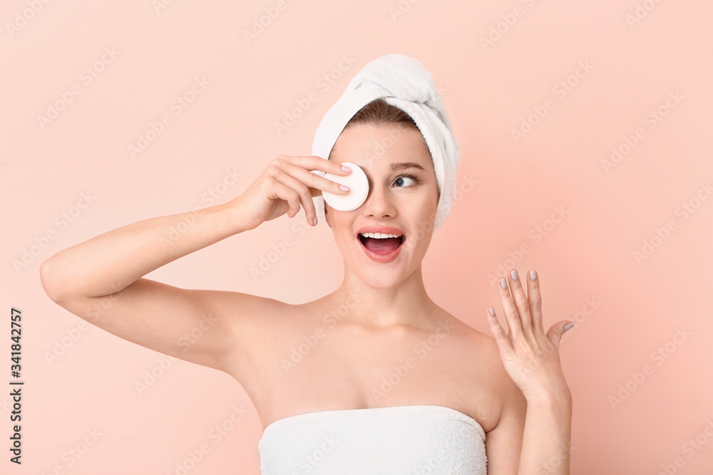 Beautiful young woman with cotton pad on color background Beautiful young woman with cotton pad on color background