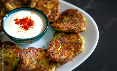 Obraz na plátně zucchini meal with pumpkin on white plate with yogurt (turkish mucver)