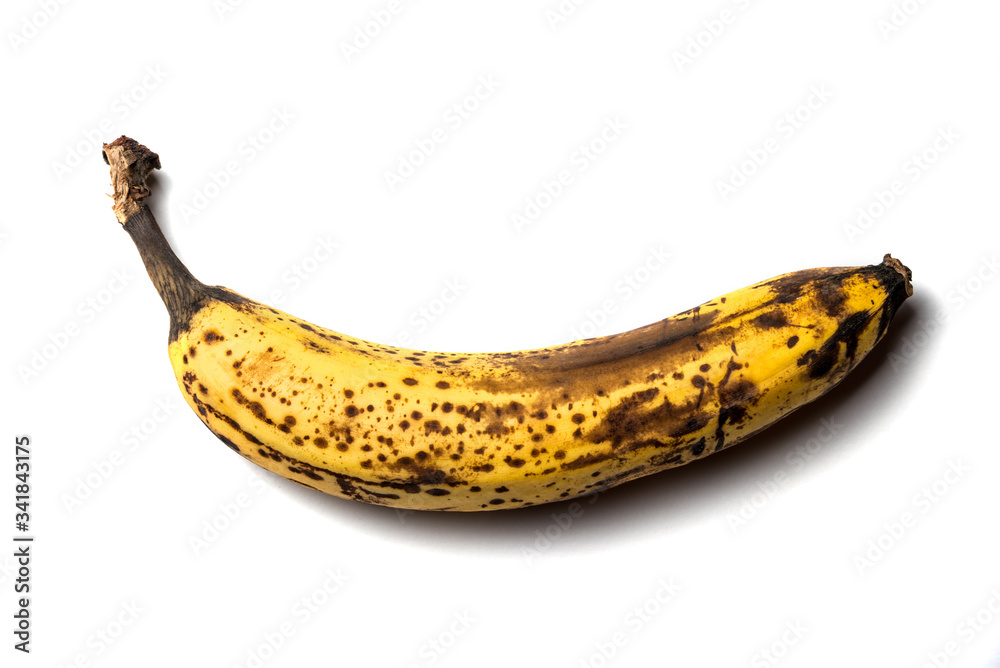old banana with spots, on a white isolated background. Horizontal frame