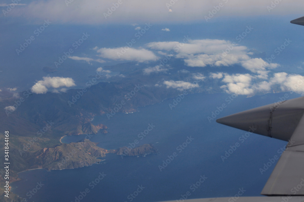 Views from an airplane window of the blue sky the sea of flowers in indonesia and the island of flowers Views from an airplane window of the blue sky the sea of flowers in indonesia and the island of flowers