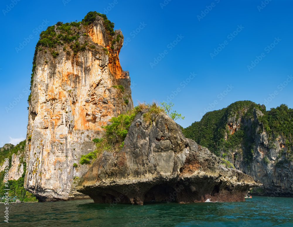 Panoramic beautiful green beach landscape, exotic scenery with rocks and blue waters of Andaman sea in Krabi Province, Thailand. Paradise tropic island and beauty of Thai nature