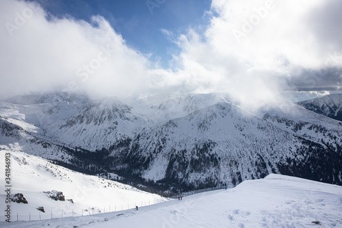 Sunset in Kasprowy wierch in Polish Tatra Mountains in winter snow weather conditions Kasprowy wierch High Tatras. Panoramic winter view of west Tatra mountain.