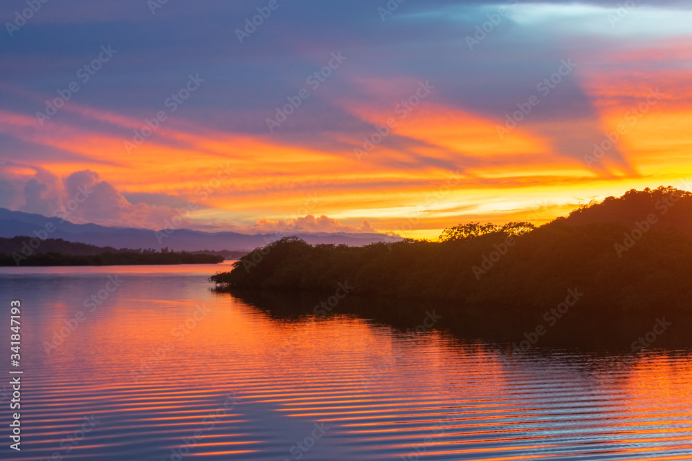 Sunrise over mangrove island in calm bay of Bocas Del Toro, Panama