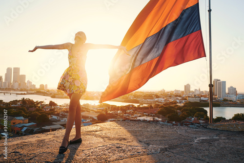 colombian flag and girl in golden and optimist sunshine full of patriot        photo