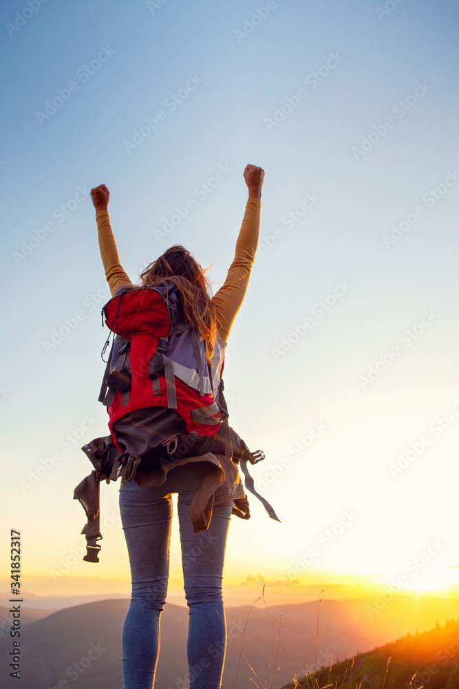 cheering woman hiker open arms at mountain peak cheering woman hiker open arms at mountain peak