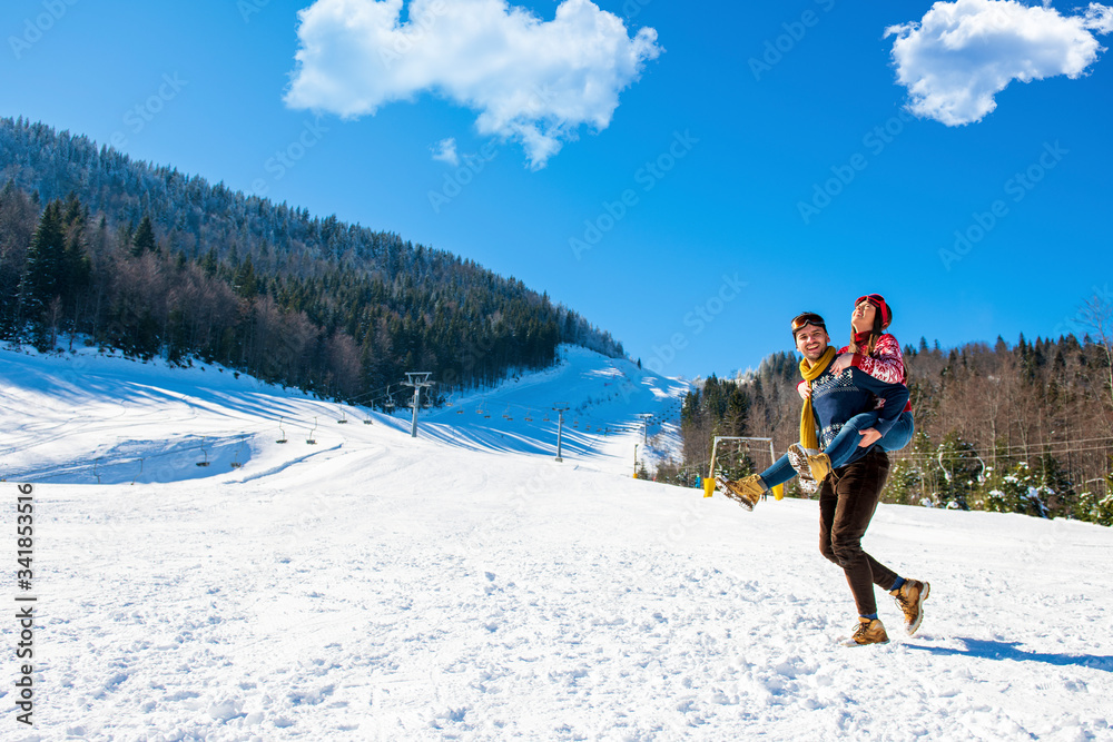 happy couple having fun over winter background