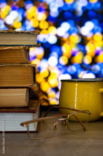 Library of books, time to read with a cup of coffee. Multicolored bokeh