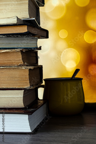 Library of books, time to read with a cup of coffee. Multicolored bokeh