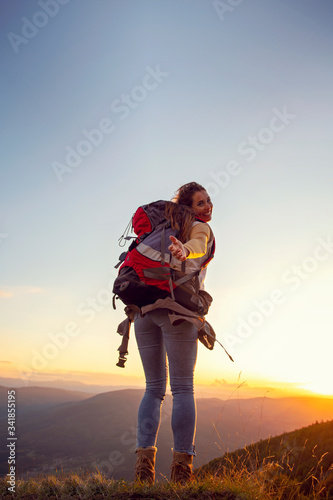 Woman Hiker giving helping hand to teammate