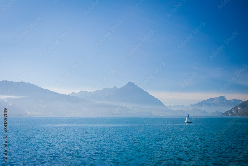 Boat in the blue waters of the Thunersee in Interlaken, Switzerland.