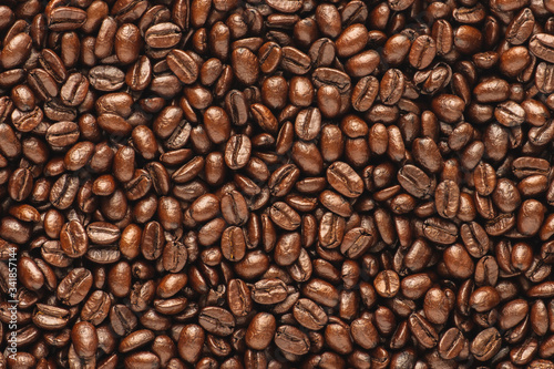 Dark roast coffee beans background, top view