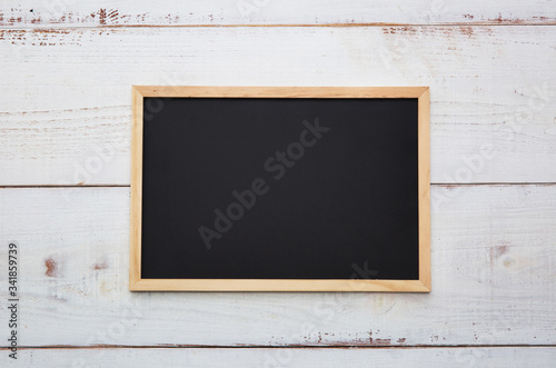 blackboard with a wooden frame on a wooden background