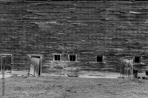 black and white Abandoned weathered barn, close-up view rustic wall.