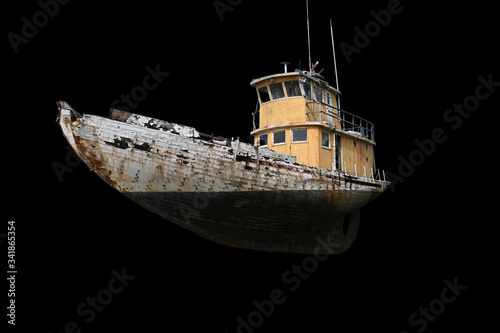 Fotografie Old ruined fishing boat isolated on black