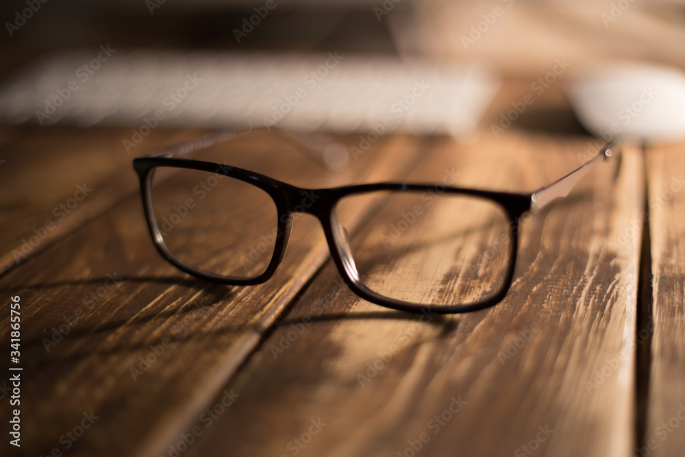 Glasses for sight and vision correction and protection from computer on the wooden table Glasses for sight and vision correction and protection from computer on the wooden table