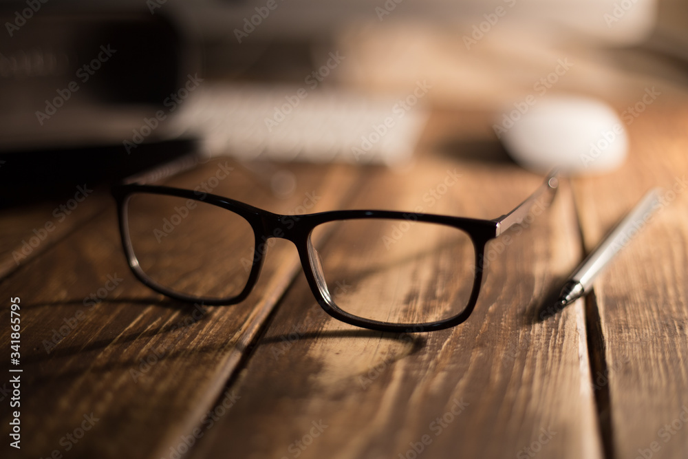 Glasses for sight and vision correction and protection from computer on the wooden table Glasses for sight and vision correction and protection from computer on the wooden table