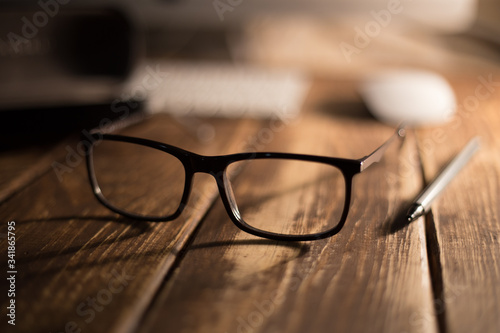 Glasses for sight and vision correction and protection from computer on the wooden table