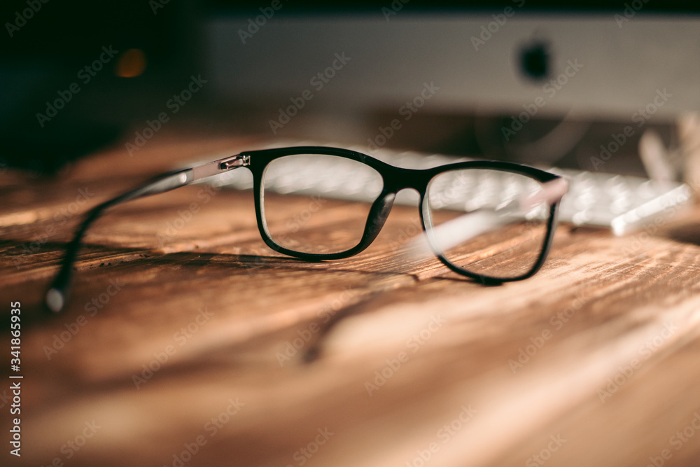 Glasses for sight and vision correction and protection from computer on the wooden table Glasses for sight and vision correction and protection from computer on the wooden table