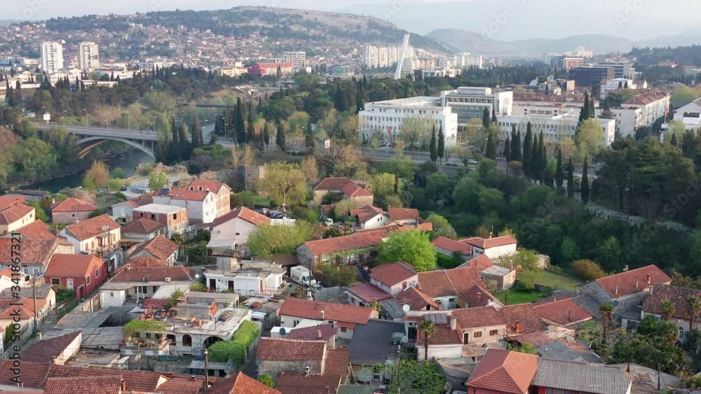 Podgorica Montenegro: Old part of the town and houses with red roofs on the left bank of Moraca river in downtown. Aerial view. Podgorica Montenegro: Old part of the town and houses with red roofs on the left bank of Moraca river in downtown. Aerial view.